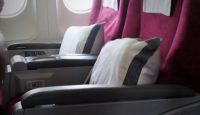 a seat with pillows and a white towel from the windows