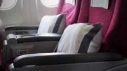 a seat with pillows and a white towel from the windows