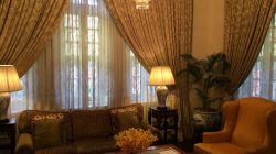 a living room with a chandelier and couch