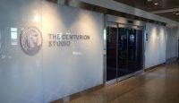 a building with glass doors and a sign