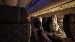 a man and woman sitting in an airplane