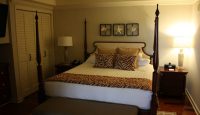 a bed with zebra print pillows and a lamp