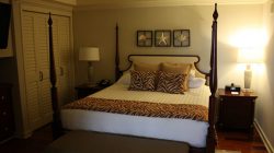 a bed with zebra print pillows and a lamp