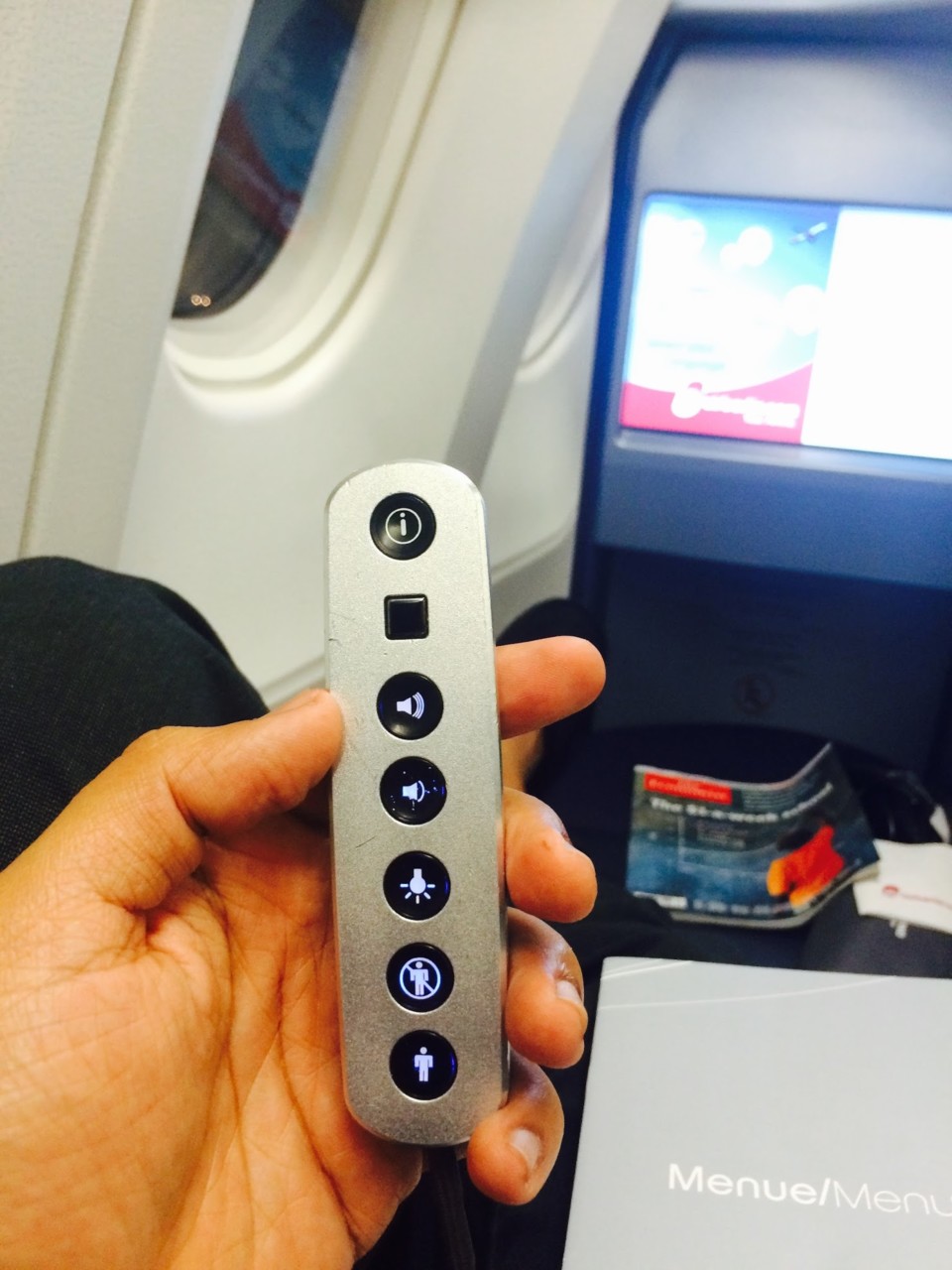 a hand holding a remote control