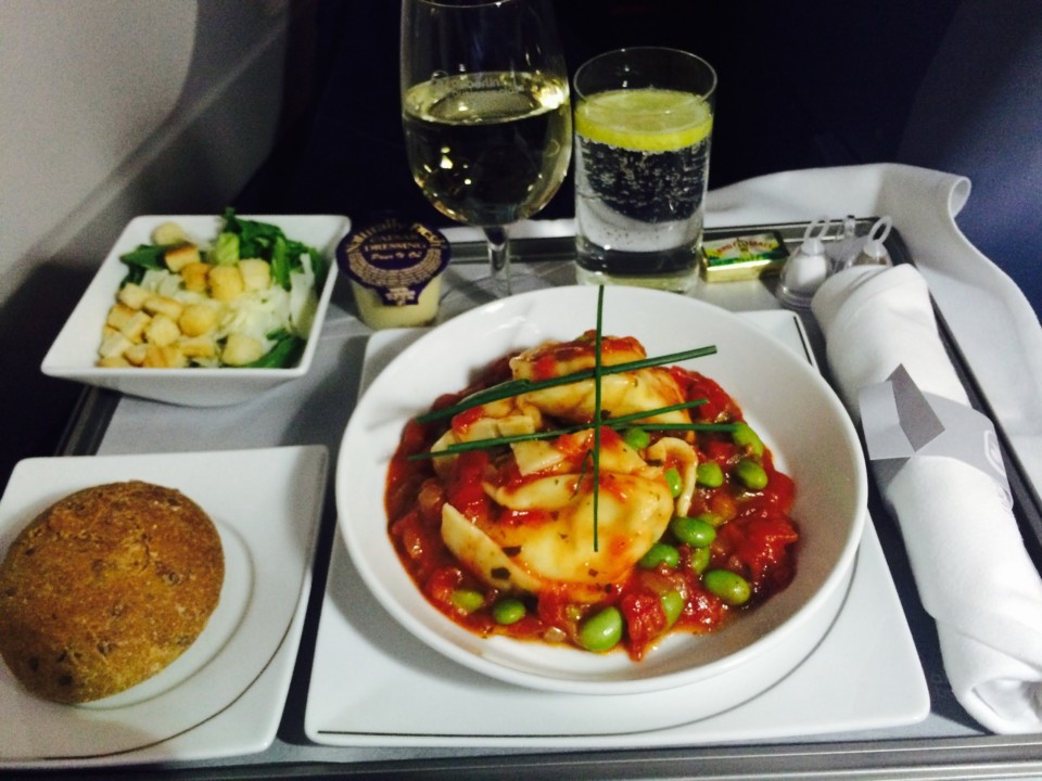 food on a tray with glasses and a drink