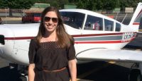 a woman standing in front of a plane