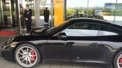 a black sports car parked in front of a building