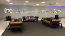 a room with couches and a drawing of a city