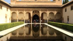 a pool of water in front of Alhambra