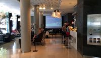 a room with columns and people sitting at tables