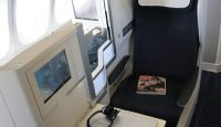 a laptop on a chair in an airplane