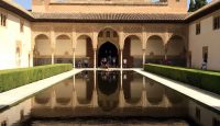 a pool of water in front of Alhambra