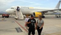 people walking on a runway with a plane