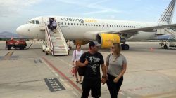 people walking on a runway with a plane