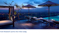 a deck with umbrellas and chairs on a rooftop