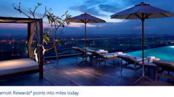 a deck with umbrellas and chairs on a rooftop