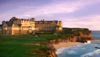 a large building on a cliff overlooking a beach
