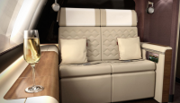 a glass of champagne in a glass on a table in a private jet