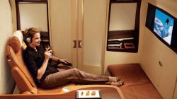 a woman sitting on a chair with a remote control