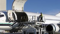 a man standing on a platform next to an airplane