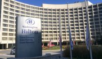 a large white building with a sign in front of it