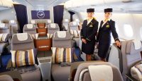 a couple of stewardesses standing in an airplane