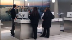 a group of people standing at a desk