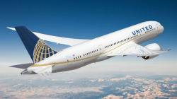 a white airplane flying in the sky