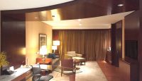 a room with a desk and chairs