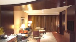 a room with a desk and chairs