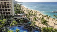 a swimming pool and palm trees on a beach