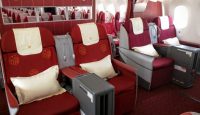 a plane with red seats and white pillows
