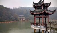 a pagoda on a dock in a lake