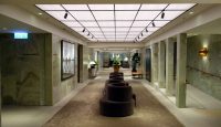 a long hallway with chairs and a large picture on the ceiling