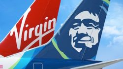 the tail fin of an airplane with a man on it