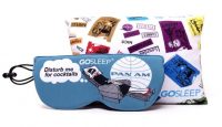 a pair of sleeping masks next to a pillow