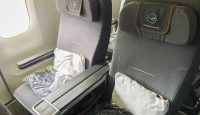 a seat with a pillow and a white pillow in it