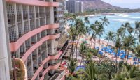 a building with palm trees and a beach
