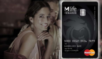 a woman smiling at a credit card