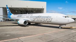 a white airplane parked in a hangar