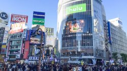 a crowd of people walking in a busy city