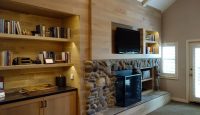 a room with a fireplace and shelves