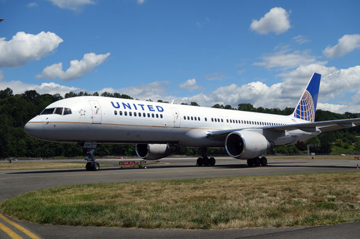 a large white airplane on a runway
