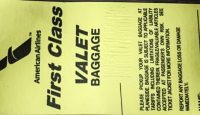 a yellow luggage tag with black text