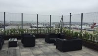 a patio with chairs and a fence