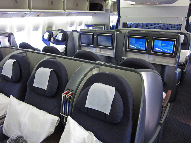 a row of seats with monitors on the side