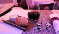 a plate of food and a glass of wine