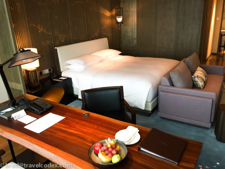 a hotel room with a bed and a desk