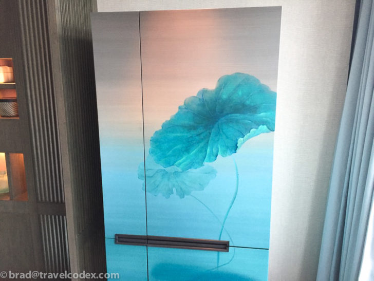 a cabinet with a painting on it