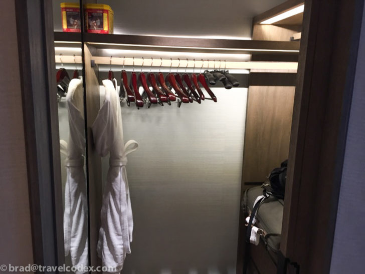 a closet with white robe and swingers
